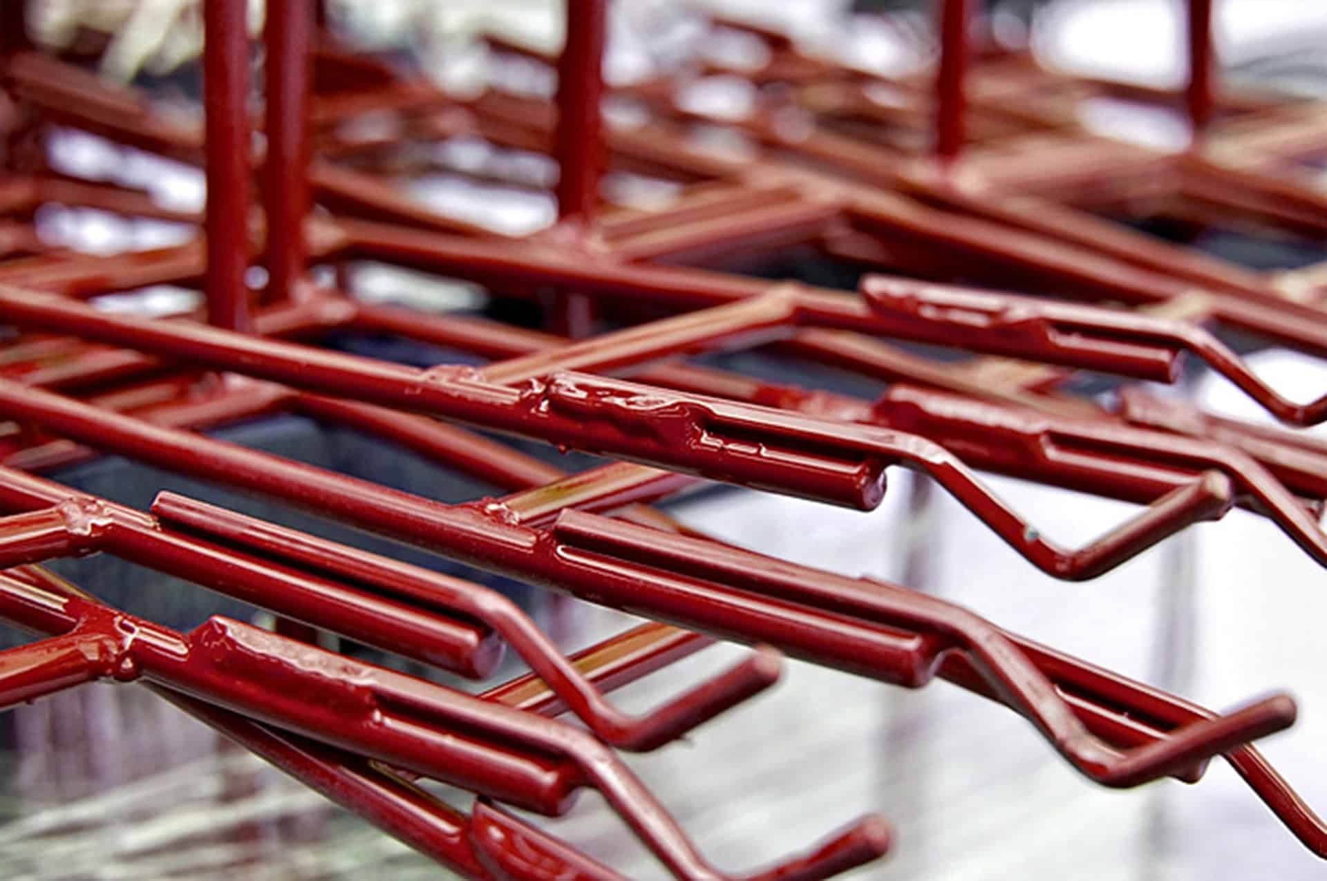Red metal paint line fixtures for high-capacity paint removal, optimizing quality and keeping your line running.
