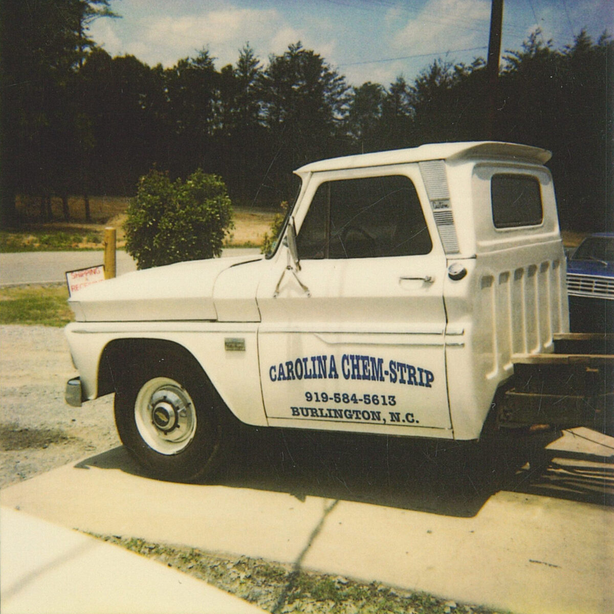 Vintage Carolina Chem-Strip truck parked, showcasing contact info. Keep your production moving.